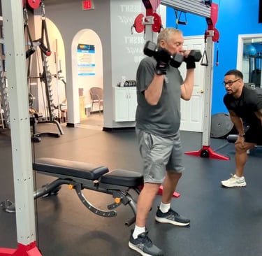 senior personal trainer in palm beach gardens cc matthews helps elderly client exercise