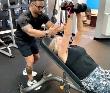 CC Matthews, personal trainer at Trinity Fitness Palm Beach Gardens, coaching a senior client