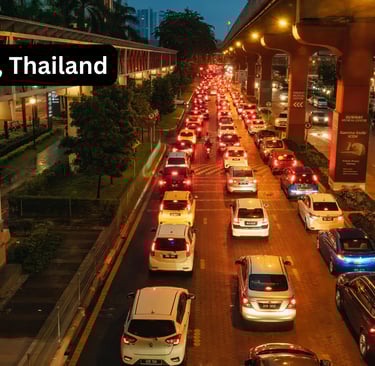 Evening traffic congestion in Bangkok Thailand with illuminated elevated highway and modern building