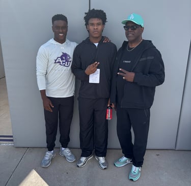 Coach DJ Williams, Adairian Alexander, and Coach Jiles at the ACU game being offered a Scholarships.