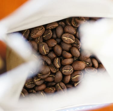 close-up shot of freshly roasted to order coffee beans in a coffee bag