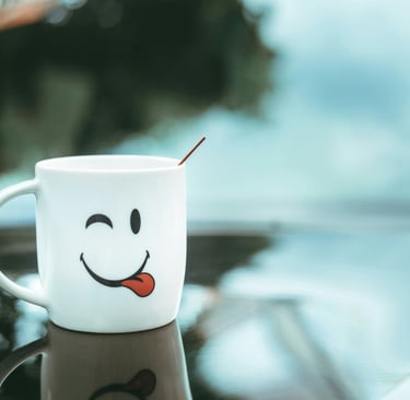 A happy and winking coffee mug sitting on top of a car