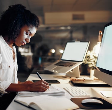 Curso de Administração e Tecnologia: Uma mulher escrevendo diante de um desktop