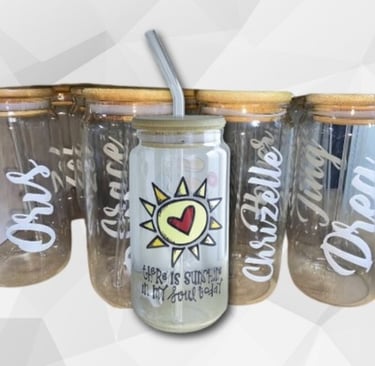 Soda glass and bamboo lid and a glass straw with a uv transfer sticker stick to it