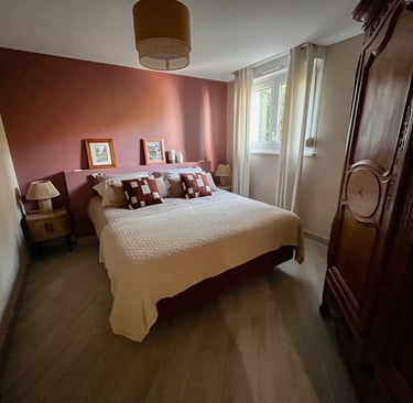 a bedroom with a bed and a wooden cabinet