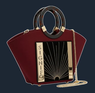 A highly structured, fan-shaped tote with a rigid frame and elegant, geometric lines inspired by Art Deco architecture.