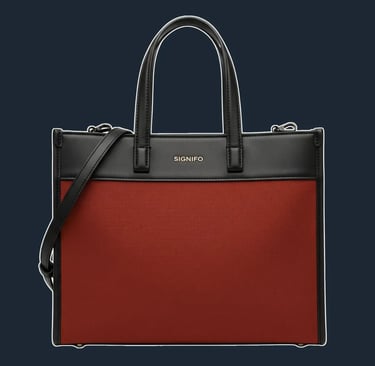 A structured, east-west tote with rectangular silhouette. The top edge and side seams are framed with leather trim