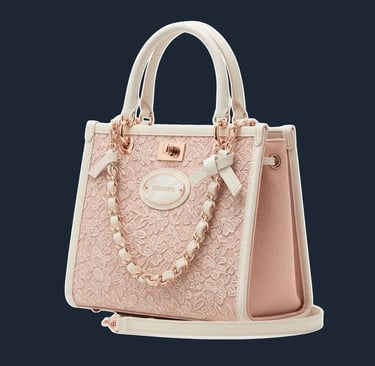A structured, top-handle tote with a classic 'lady bag' silhouette and delicate, accordion-style side gussets.