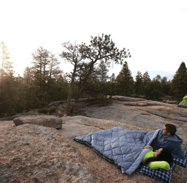 Couple cozy camping in Coleman Tandem double sleeping bag, best double sleeping bag for couples