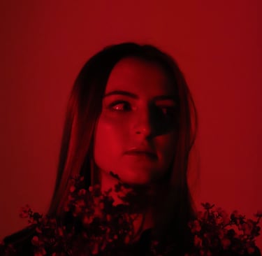 Photo of Audra Baruch in a red light