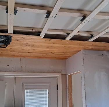 Wood ceiling framing installation in progress for residential levelling renovation project in Canada