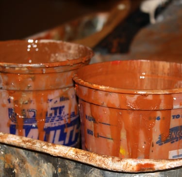 Close up of paint cups in burnt sienna