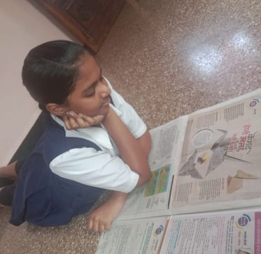 A girl student reading Origami article in Sakal NIE