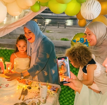 a woman is holding a cell phone and a child