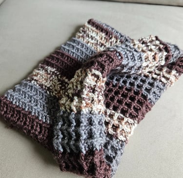 a neutral colored crochet cowl