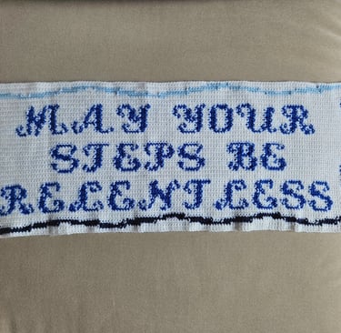 a crochet tapestry on a couch