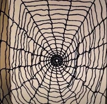 a black crochet spider web
