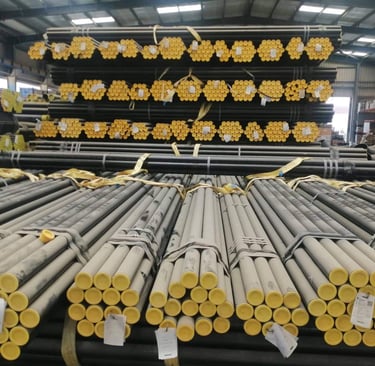 a large amount of pipes and pipes are stacked up in a warehouse