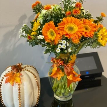 a vase with flowers in a vase on a table