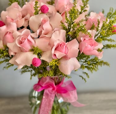 a vase with pink roses in a vase