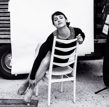 Actress Silvana Veit stretching  out on a chair.