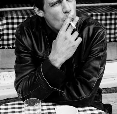 Detlef Cooper sitting by a table with a coffee cup.