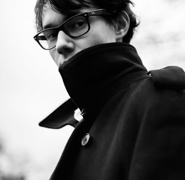 Portrait of filmmaker Emile Rafael wearing a coat.