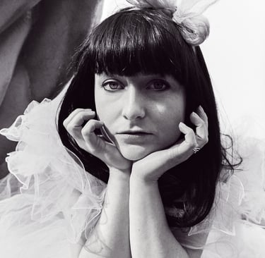 A brunette wearing a bow in an 80s prom dress.