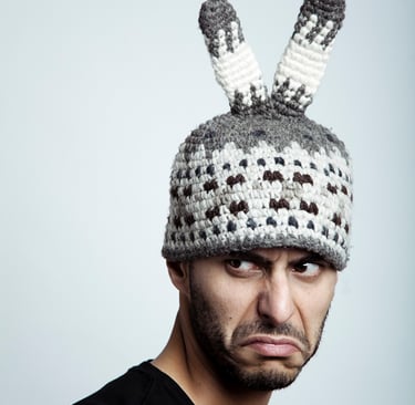 Ray Mann photographed with a grimace with a funny hat.