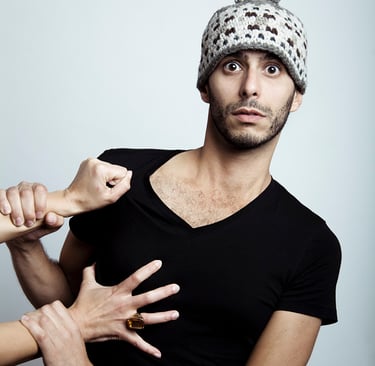 A man with a funny hat with ears being pulled by a woman.