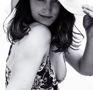 A young woman with a plunging neckline dress and a straw hat.