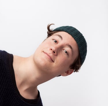 A young man with a green hat.