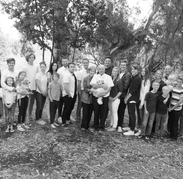 Family picture, black and white, in woods.