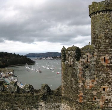 Welsh castle overlooking river and boats in circle