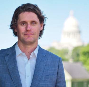 Arkansas Criminal Defense Lawyer Kale Ludwig poses in front of State Capital Building
