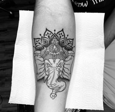 Black and Grey Ganesha tattoo with mandala design by tattoo artist at Dudo’s in Hyderabad