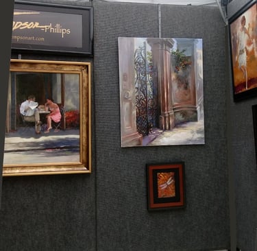 Art show paintings inside tent