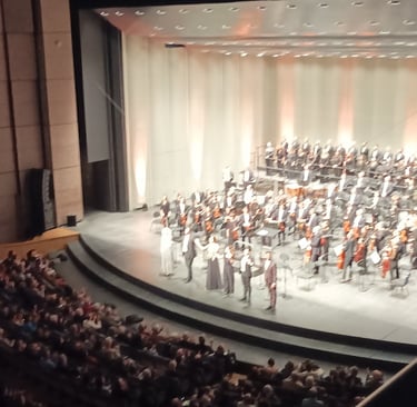 The choir, orchestra, conductor and soloists all take a bow.