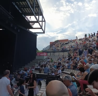 The audience gathers as night falls