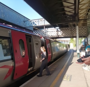 The train manager has blown her whistle and returns to the carriage