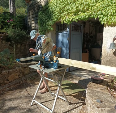 Sawing off three ends to give the roof a slight angle.