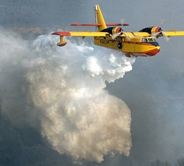 A Canadair releasing watr on a fire