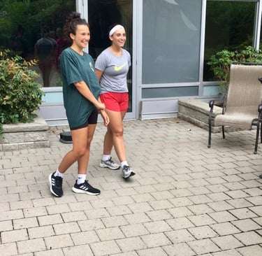 Two women after Jeet Kune Do North York training in a courtyard area.