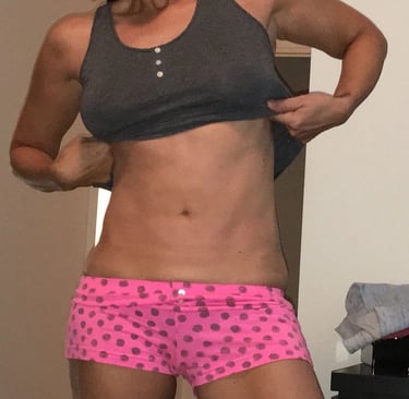 a woman in a pink polka dotty shortsuit and a black tank top