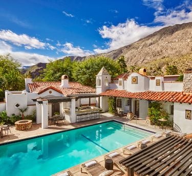 Lucille Palm Springs pool and terracotta roof with mountains in the background