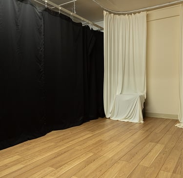 a black curtain in a room with a curtain