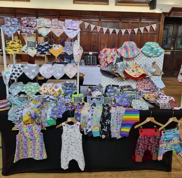 a table with clothes and clothes on it all handcrafted by distinctly individual
