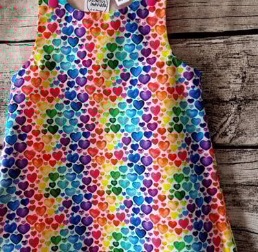 a colourful rainbow heart print dress for children