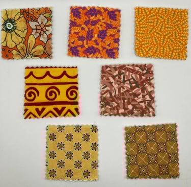 Collection of seven vintage patterned fabric swatches in warm orange, yellow, and brown tones.