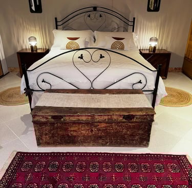 Elegant double bedroom in luxury villa in Siracusa, Sicily with rustic wooden chest, Villa Incanto on the Sea